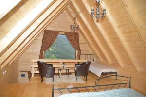 a dining room with a table and chairs and a window at Weekend house Lokve - Modern in Berane