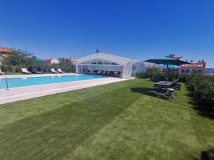 a yard with a swimming pool and a house at Apartamentos Plateria in O Grove