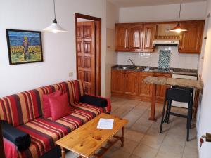 a living room with a couch and a kitchen at Apartamentos La Fuente in Santa Cruz de la Palma