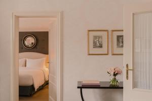 a bedroom with a bed and a table with a vase of flowers at Hotel Bristol, A Luxury Collection Hotel, Warsaw in Warsaw