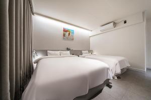 Postel nebo postele na pokoji v ubytování Hotel Yam Gumi