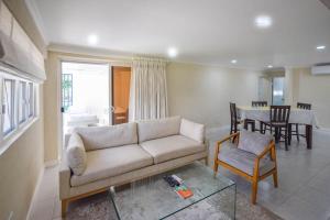 a living room with a couch and a table at Blue Waters 25 5 bed apts in Bridgetown