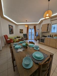 a dining room and living room with a table and chairs at Kouriton apartment is an ideal place to relax in Gouves
