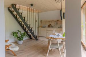 a kitchen with a table and a staircase in a room at Tiny Eko House Bovec in Bovec