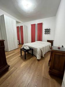 a bedroom with a bed and a table in it at Casa di Carmignanello in Cantagallo