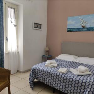 a bedroom with a bed with two towels on it at Mediterraneo Camere in Otranto