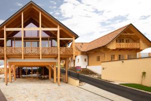 a timber house with a gambrel roof at Fräulein Leni Hotel in Gamlitz