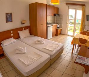 a bedroom with a bed with two towels on it at Monachus Monachus in Frangokastello