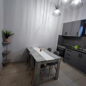 a kitchen with a table and chairs in a room at Mouzakitis Apartments 4 in Arillas