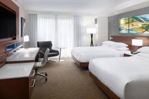 a hotel room with two beds and a desk at South Sioux City Marriott Riverfront in South Sioux City