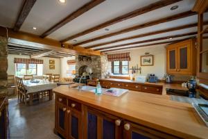 a large kitchen with wooden counters and a table at The Manor in Little Dean
