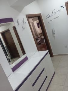 a dressing room with mirrors on the wall at Elena's flat in Kumanovo