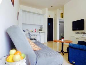 a living room with a couch and a table with a bowl of fruit at Perfect Sea View in Bat Yam