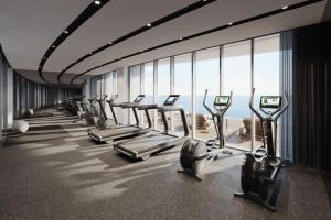 a gym with a row of treadmills at Del Mar Beachfront Boutique Residence in Limassol