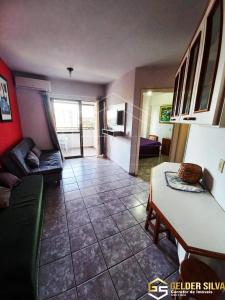 a living room with a couch and a table at Golden Thermas Centro ao lado do CTC in Caldas Novas