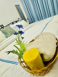 a basket on top of a bed with flowers on it at Sea Breeze Guest House in Negombo