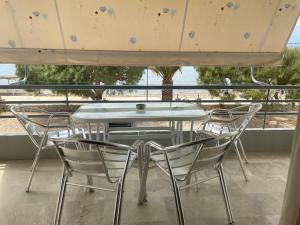 a table and chairs with a view of the ocean at Finikas in Iria