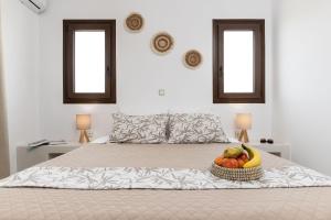 a bed with a basket of fruit on it at Naxian Air in Agios Georgios
