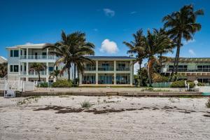 a large house on the beach with palm trees at Vista Mar in St Pete Beach