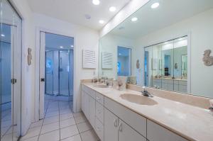 a bathroom with two sinks and a large mirror at Vista Mar in St Pete Beach