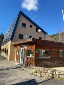 budynek z drzwiami przed nim w obiekcie camping hôtel les airelles w mieście Saint-Cirgues-en-Montagne
