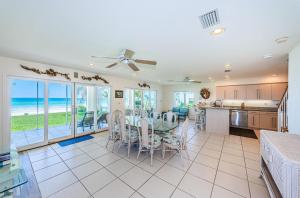 a kitchen and dining room with a table and chairs at Vista Mar in St. Pete Beach