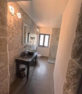 a bathroom with a sink and a mirror on the wall at Sole Azzurro Suite in Bosa