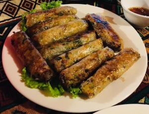a plate of food with sausages on a table at Sapa Local Guide Homestay Trek 2 Days 1 Night or Multi-Day Trekking in Lao Cai