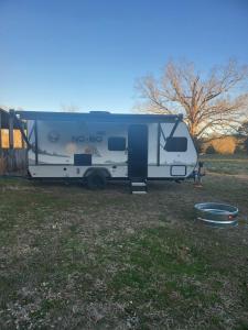 a white rv parked in a field at Island Breeze RV in Covington