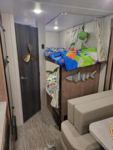 a small room with a bunk bed and a closet at Island Breeze RV in Covington