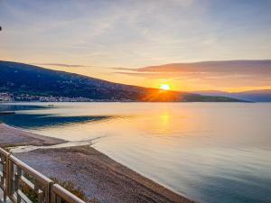 a sunset over a body of water at Hotel Dobrovit in Baška