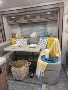 a living room with a table and a couch at Island Breeze RV in Covington