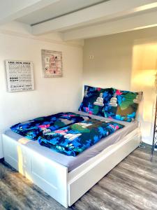 a bedroom with a bed with a blue comforter at House of Happiness mit Seeblick in Hungen