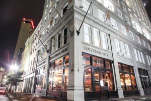 a building on the corner of a street at night at Q&C Hotel and Bar New Orleans, Autograph Collection in New Orleans