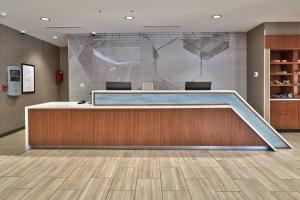 an office lobby with a desk and a large screen at SpringHill Suites Durango in Durango