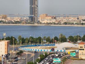 a city with a lot of traffic and the water at S Maskan Hotel in Dammam