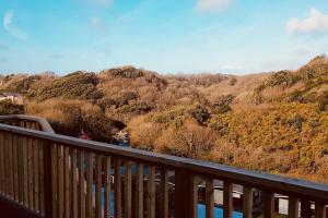 a balcony with a view of a river and trees at Summercliffe Chalet No 75 in Swansea