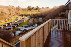 a balcony with a view of a train yard at Summercliffe Chalet No 75 in Swansea