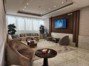 a living room with a couch and a tv at S Maskan in Dammam