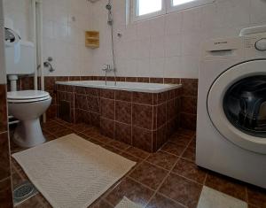 a bathroom with a washing machine and a toilet at Apartment Nina in Rovinj