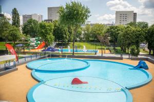 a large pool in a park with two slides at Vorto Apartament 3 - Warszawa Centrum in Warsaw