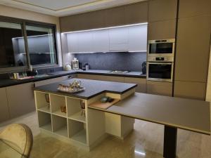 a kitchen with a island in the middle of it at Vue panoramique sur la baie de Tanger in Tangier