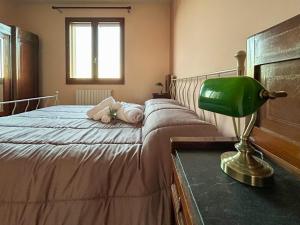 1 dormitorio con 1 cama con silla verde en Agriturismo Garzolé, en Castelfranco Emilia