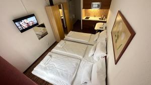 an overhead view of a room with a white bed at Hermina Apartmanok in Budapest