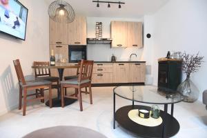 a kitchen and dining room with a table and chairs at Kala House in Zadar