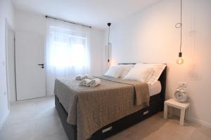 a bedroom with a bed with two towels on it at Kala House in Zadar