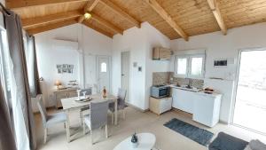 a kitchen and dining room with a table and chairs at Captain's Sea View in Vathi