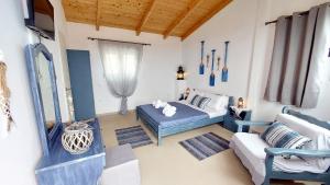 a bedroom with a bed and a couch at Captain's Sea View in Vathi