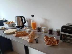 - une table avec du pain, des croissants et du jus d'orange dans l'établissement A l'Ombre des Bois, Chambre double confort, à Neung-sur-Beuvron