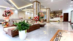 a lobby with couches and flowers in a store at Lucasta Hotel Ha Long in Ha Long
